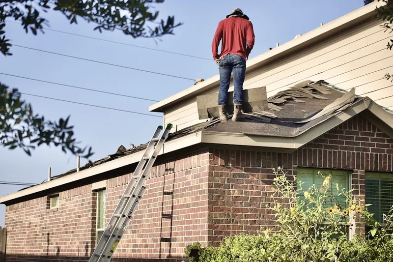 Professional roofer working on a residential roof in Spangle